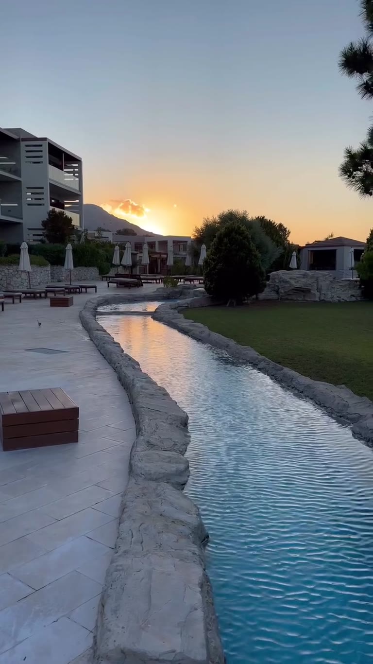 Sunset over the resort pool in Rhodes