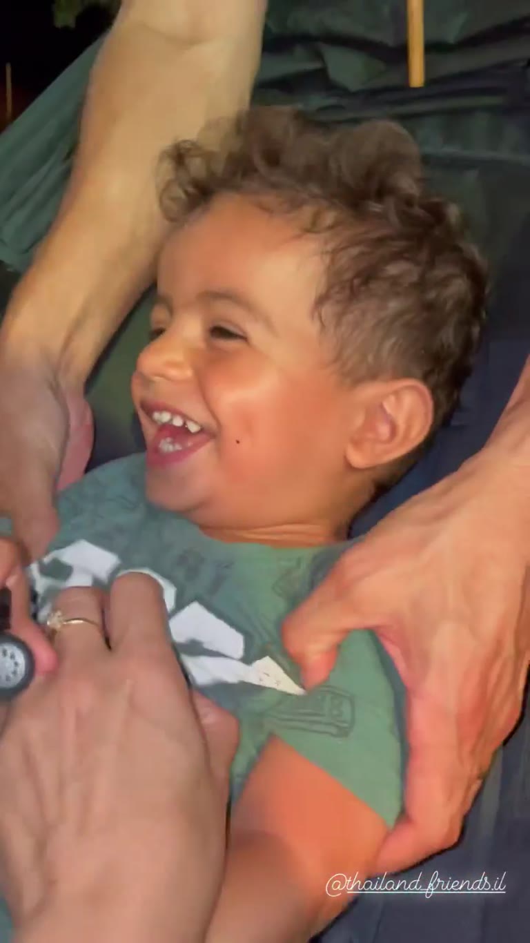 Giggling toddler in a hammock in Thailand