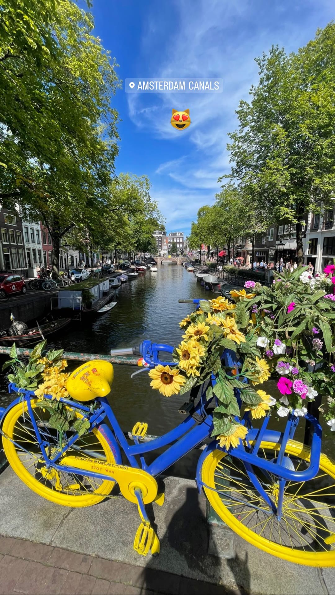 Amsterdam canals with a blue-and-yellow bike