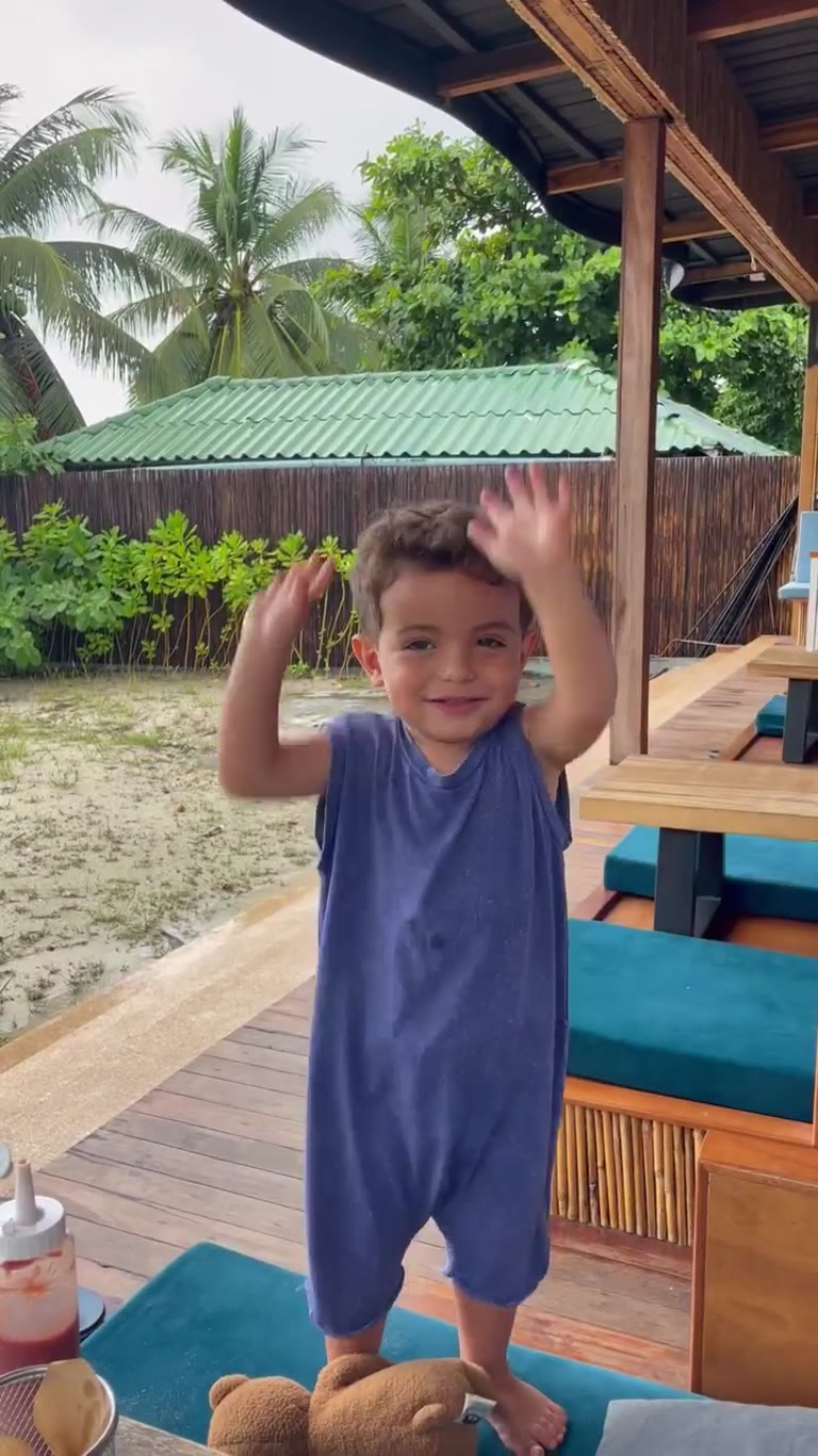 Toddler dancing at a beach café in Thailand
