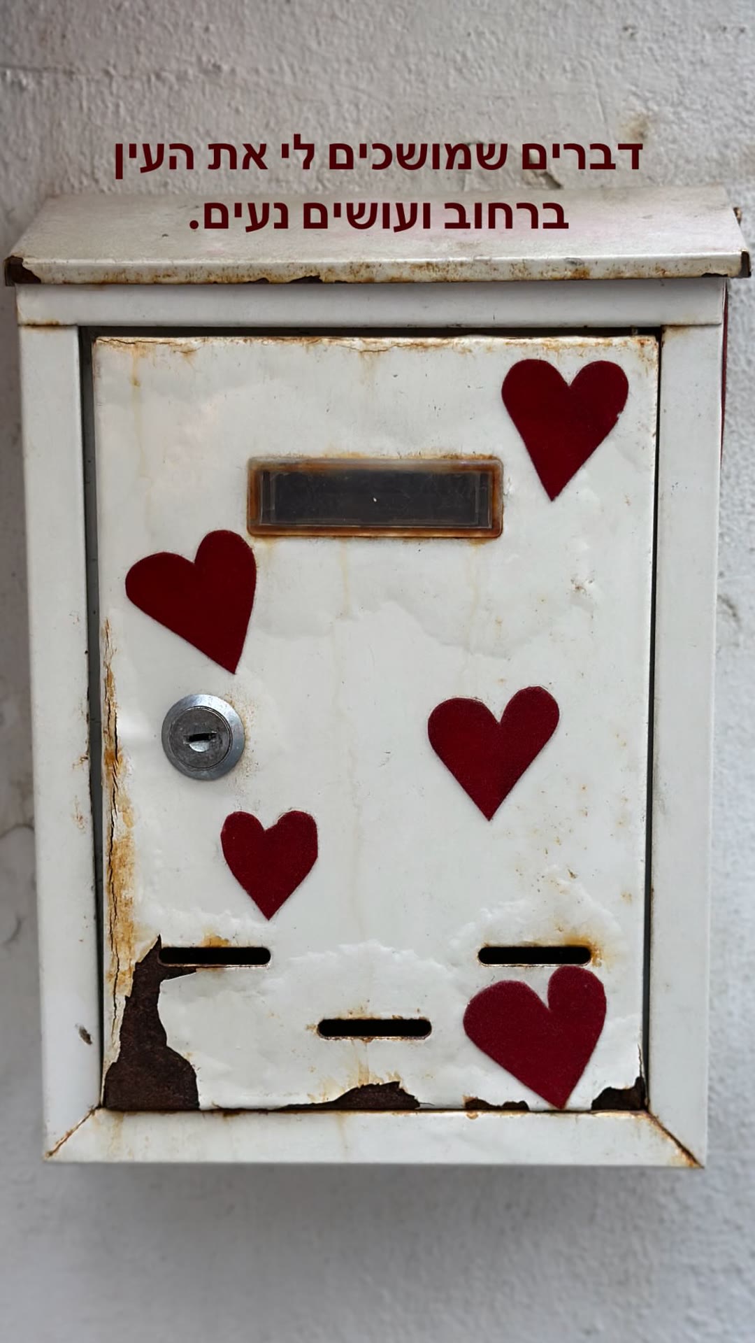 Street detail in Lisbon: a heart-covered mailbox