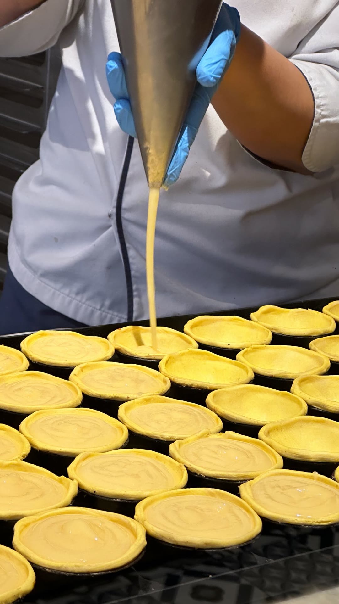 Pastéis de nata being filled in Porto