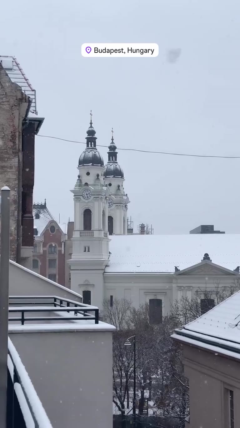 Snowfall over Budapest rooftops
