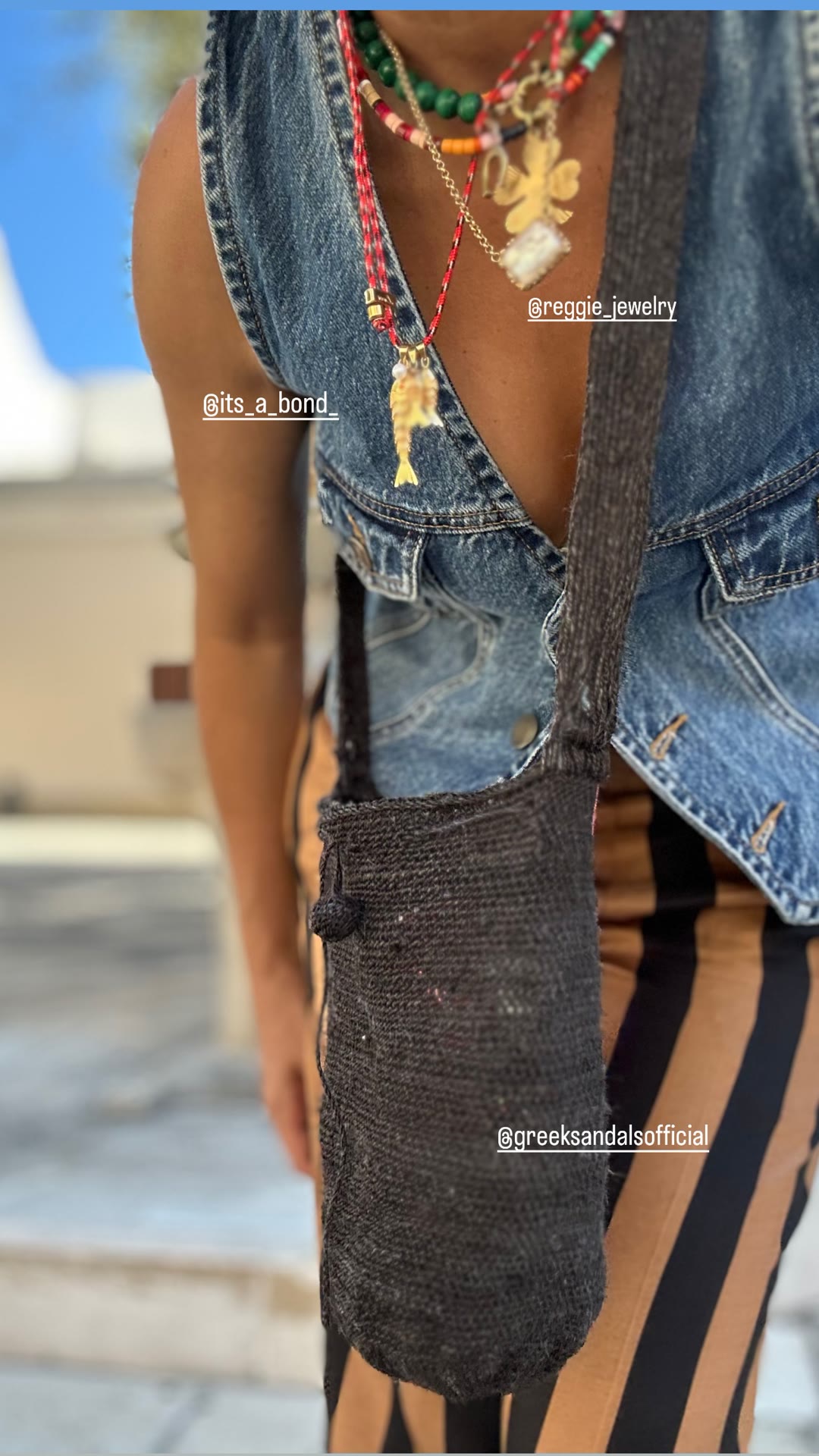 Outfit details: denim vest, charms and woven bag