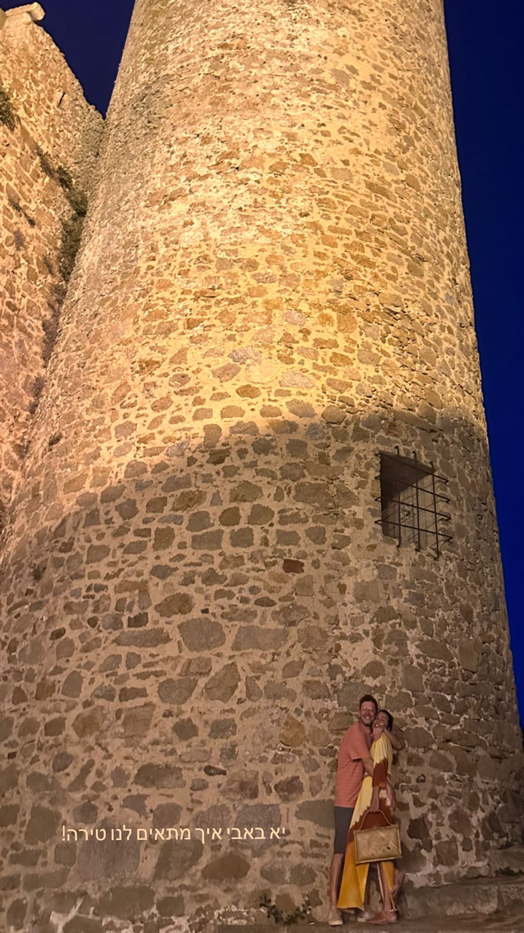 Lit-up castle tower at night in Spain