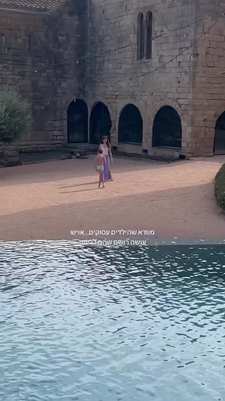 Kids by the pool at a stone villa in Spain