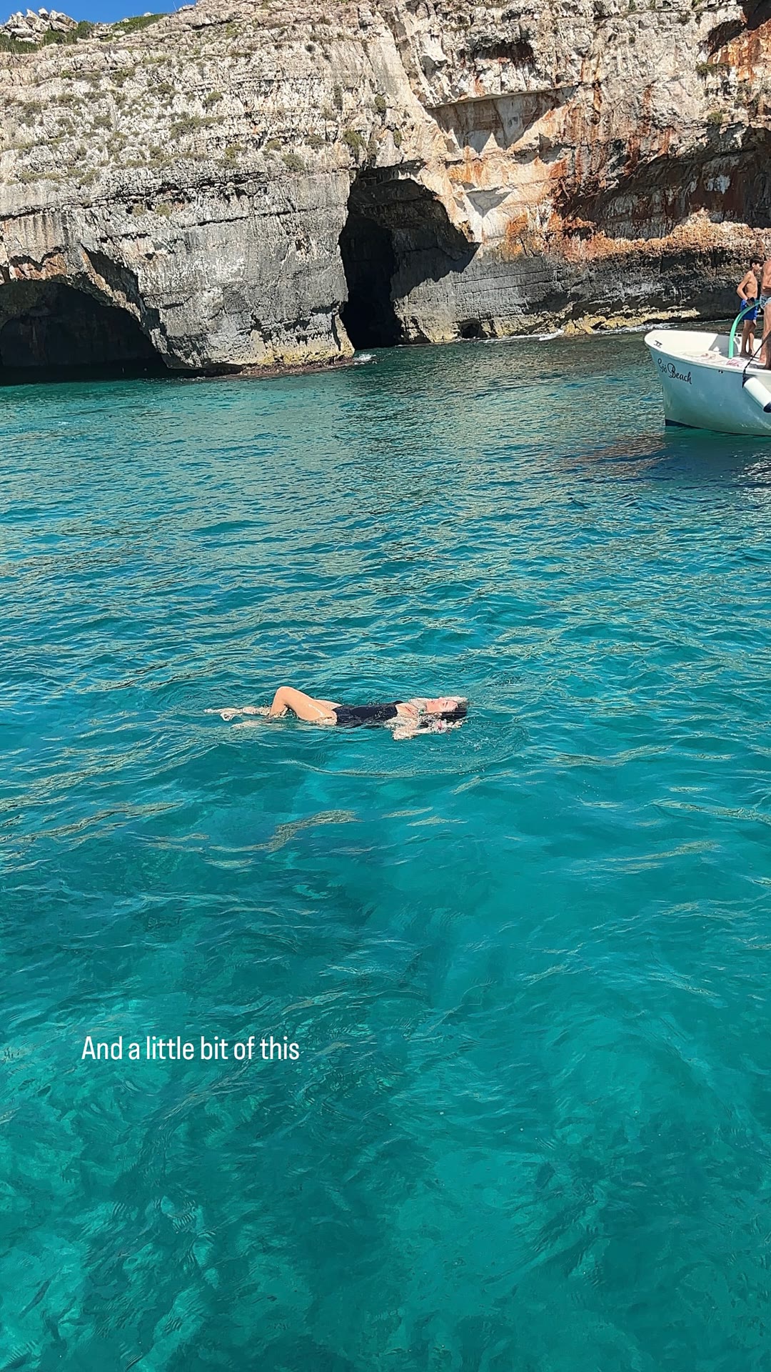 Floating in turquoise water by Puglia's sea caves