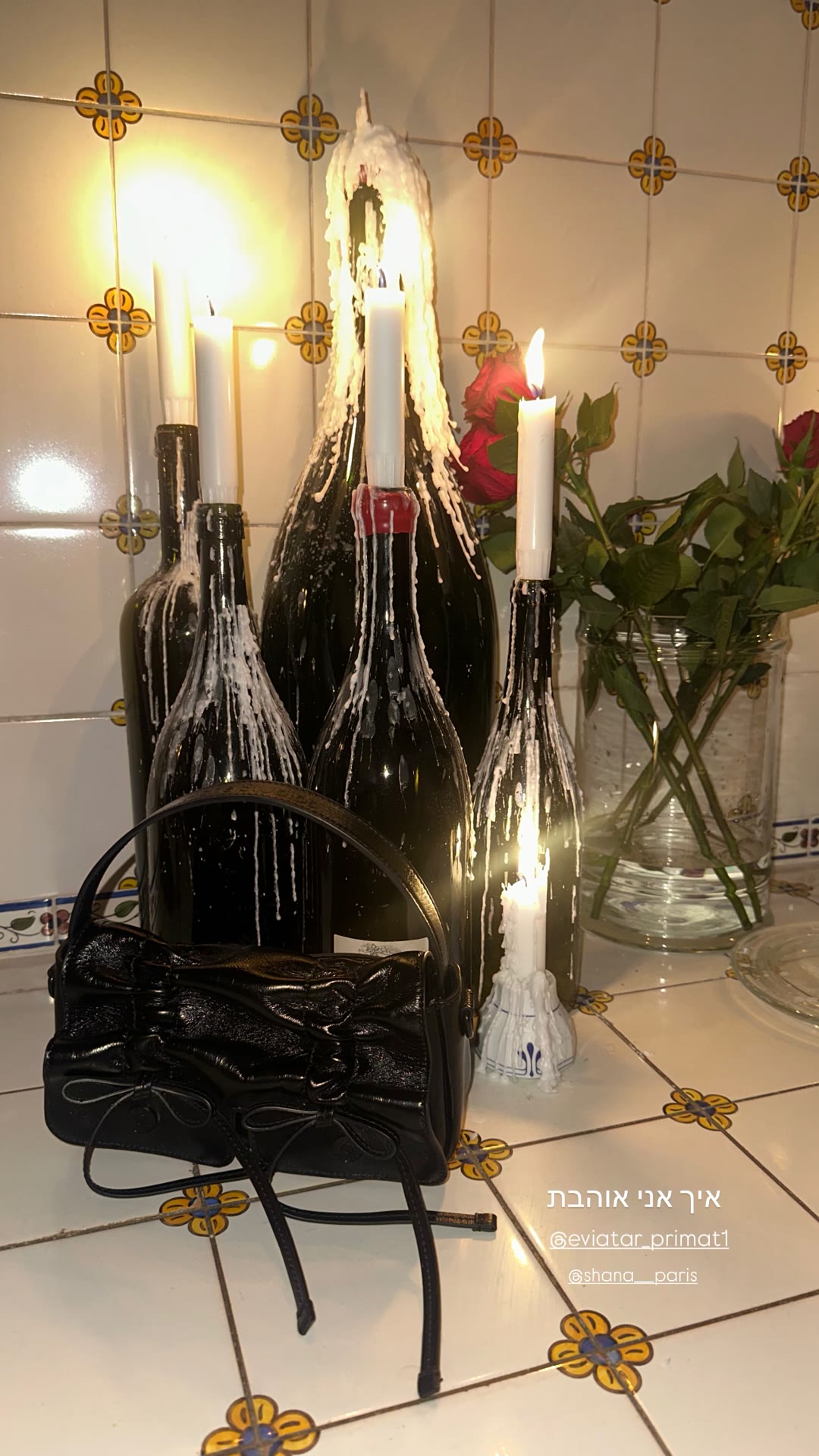 Candlelit wine bottles in a Paris kitchen