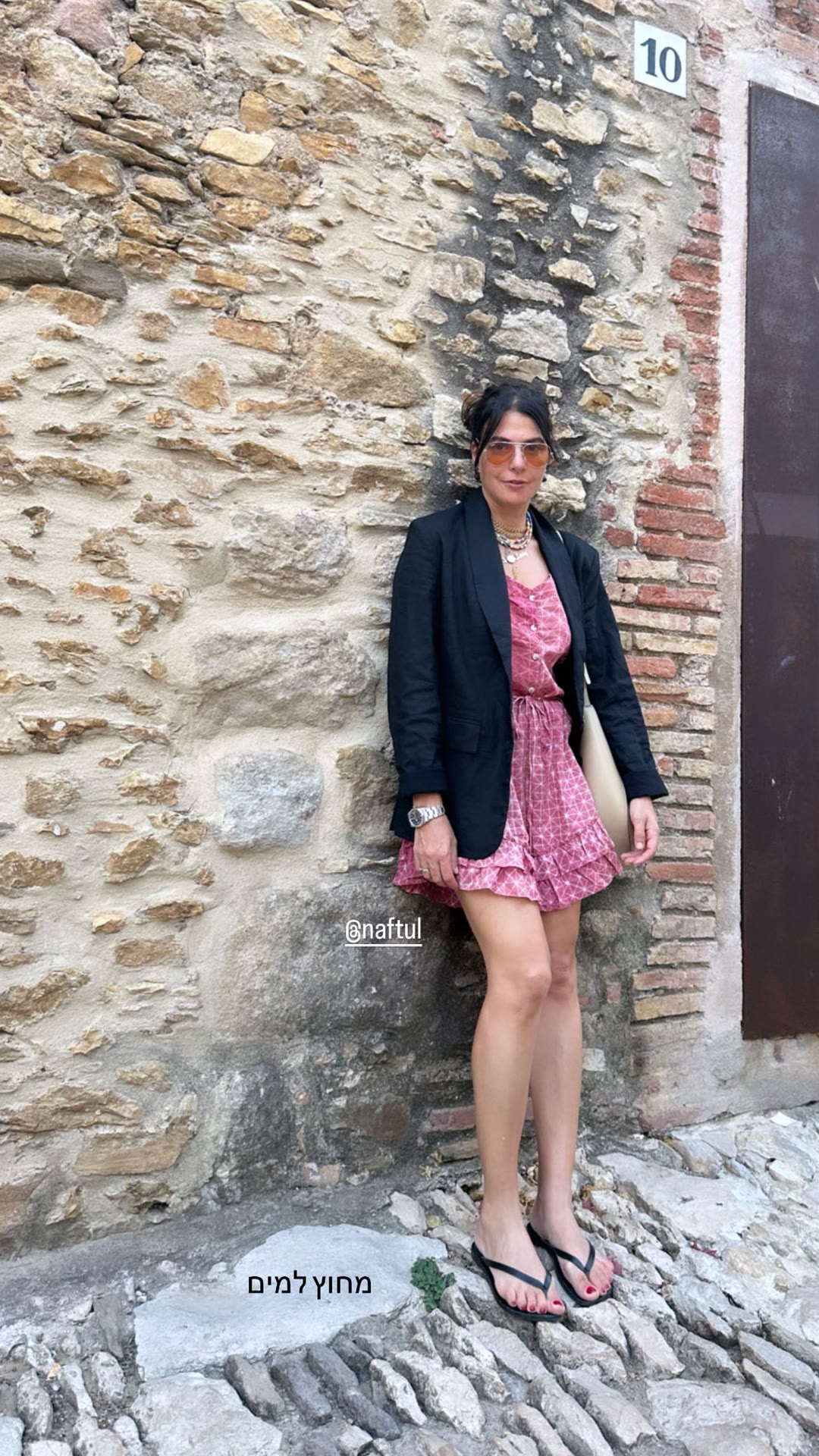 Outfit against a stone wall in Spain