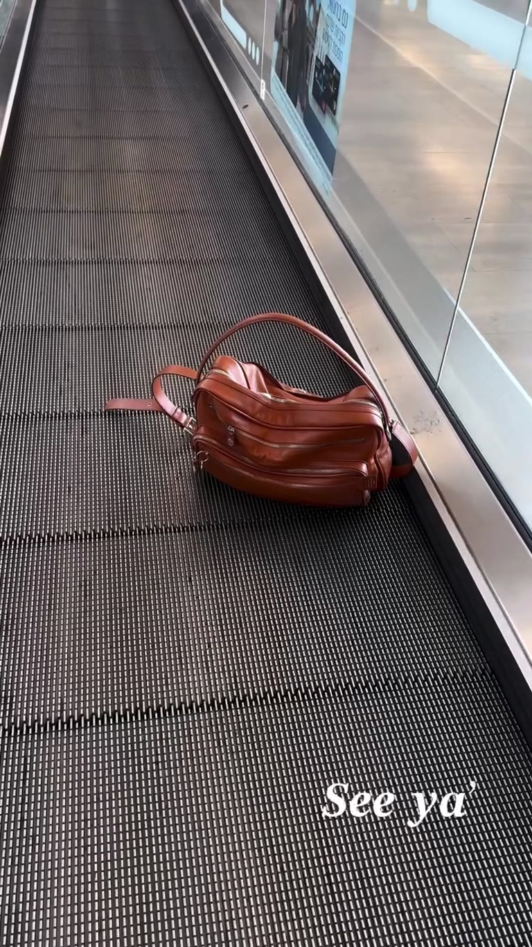 "See ya'" — leaving on an airport travelator