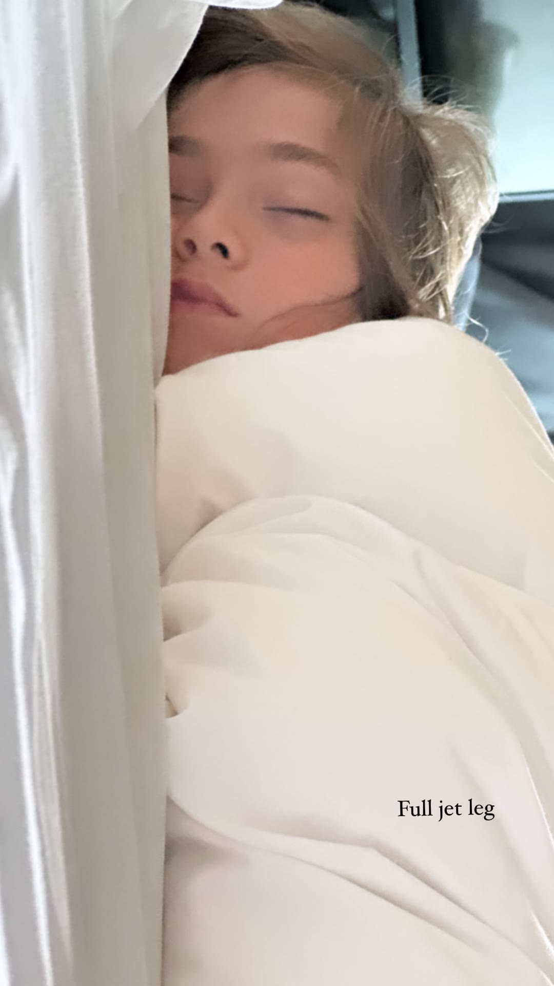 Jet-lagged kid asleep on the flight to Tokyo