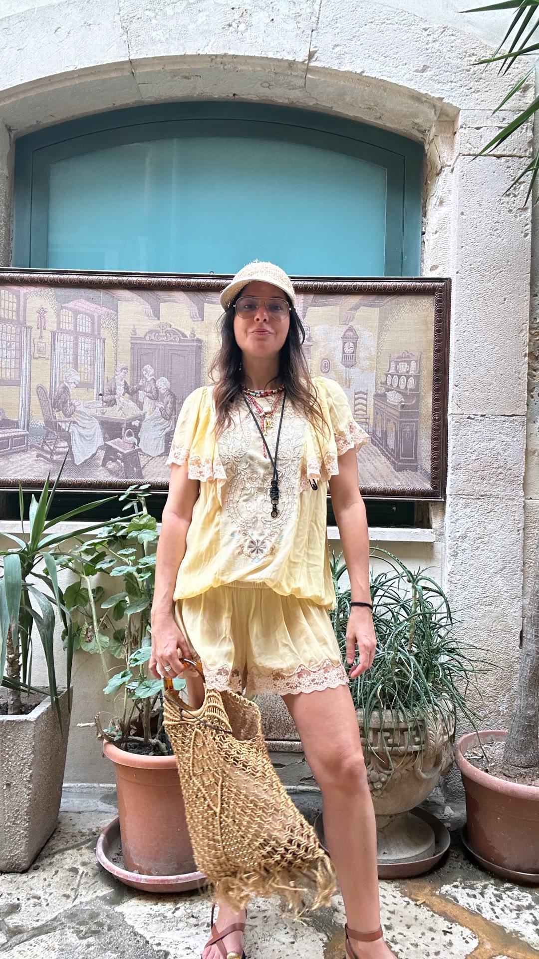 Yellow lace outfit in a Puglia courtyard