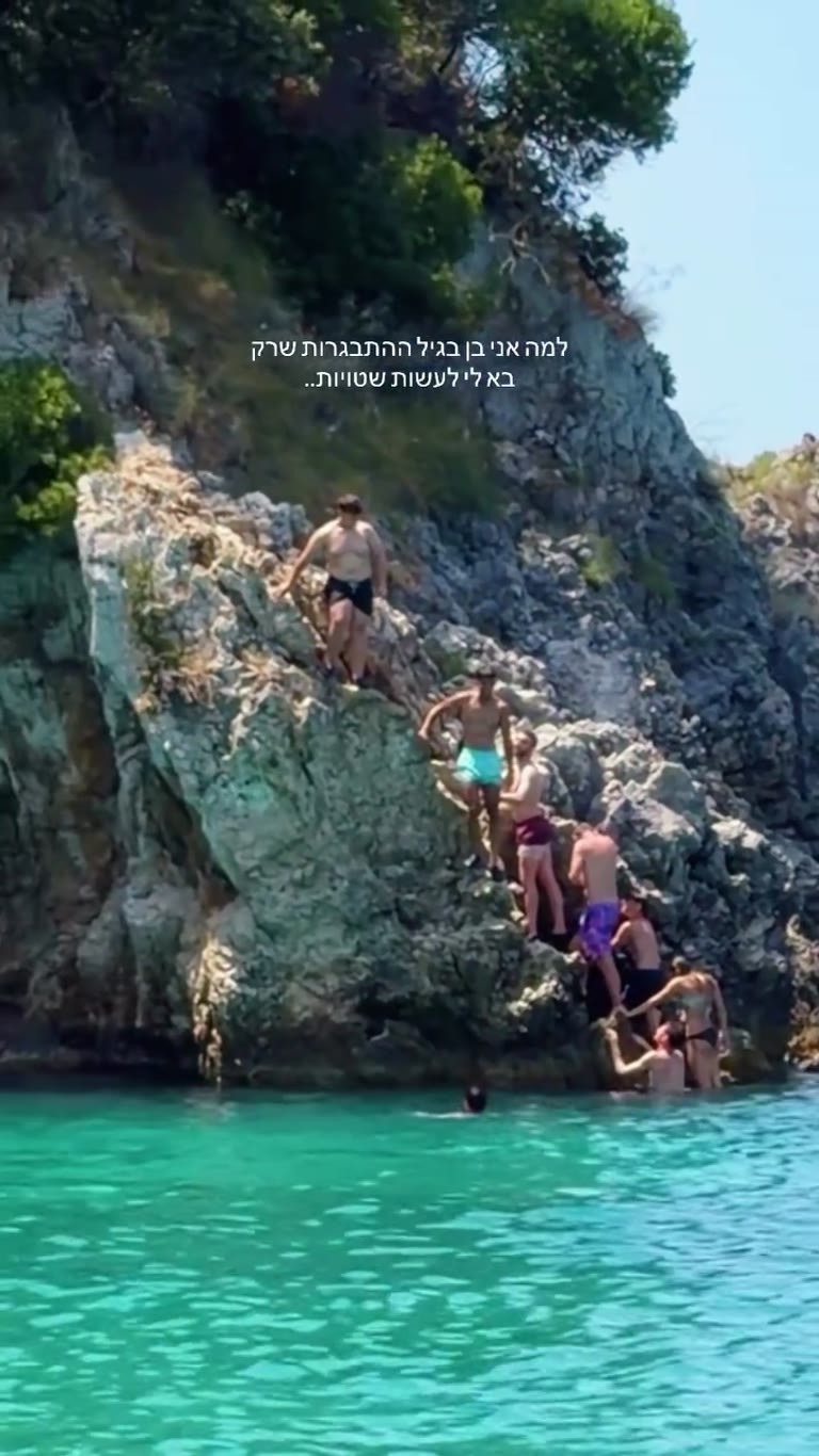 Cliff jumping into turquoise water in Corfu