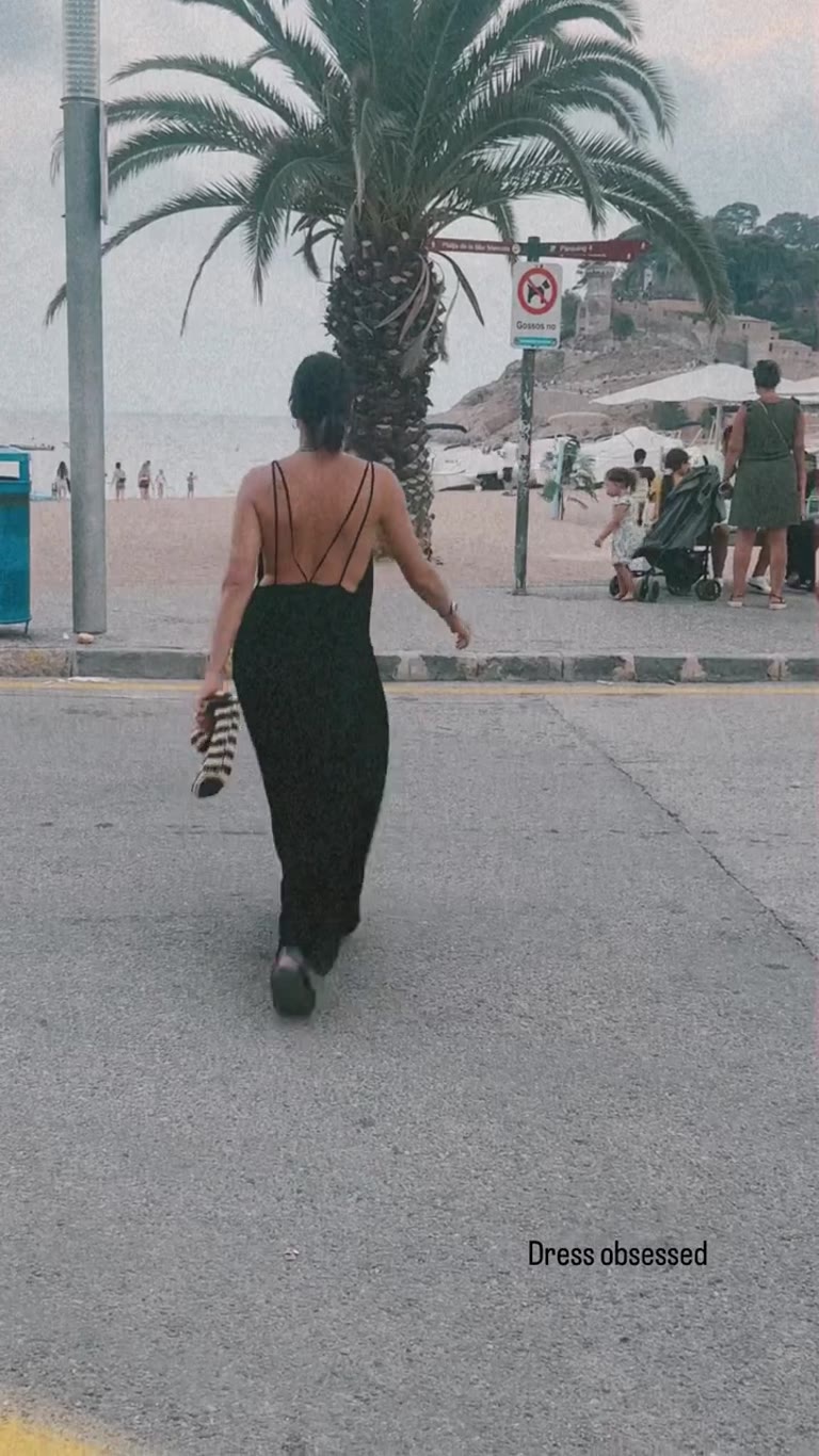 Black dress walk by Platja de la Mar Menuda, Tossa de Mar