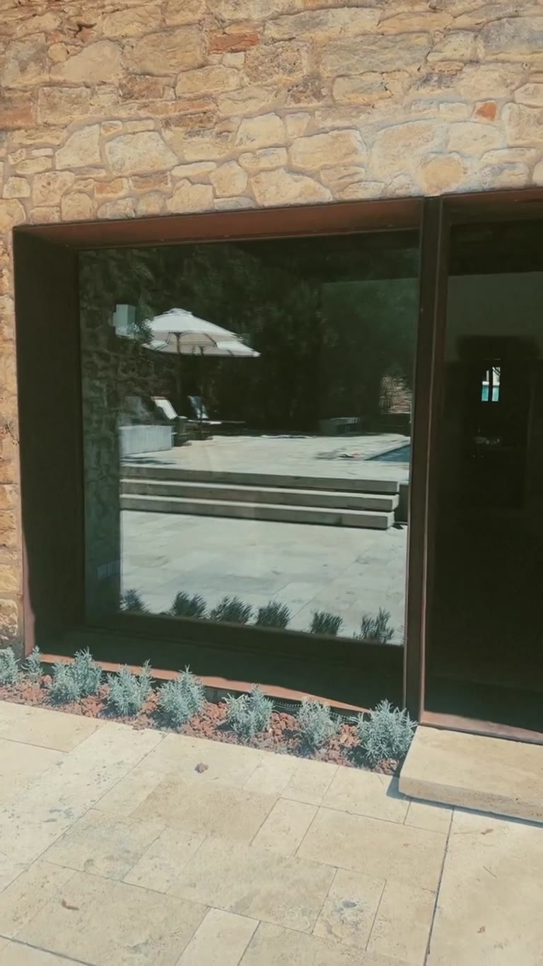 Poolside mirror selfie at a Spanish stone villa