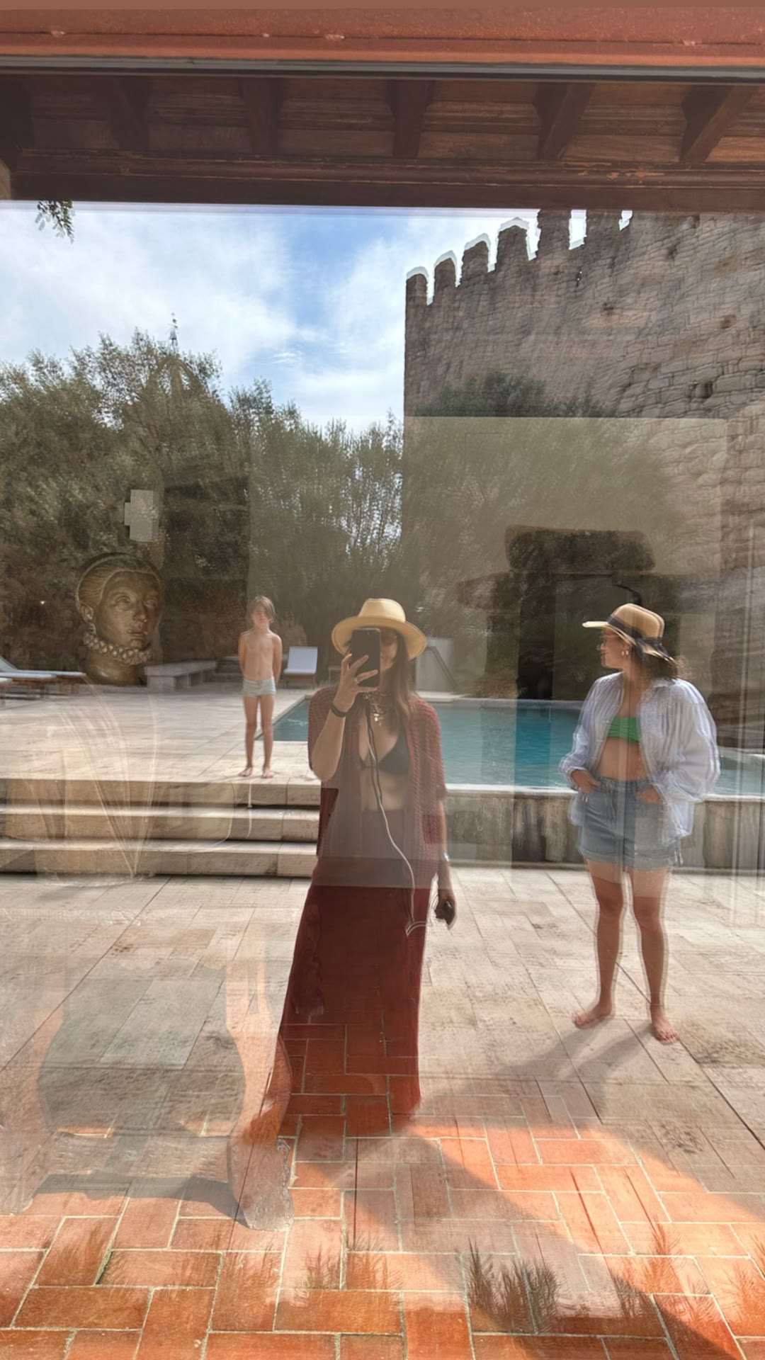 Poolside mirror selfie at a stone villa in Spain