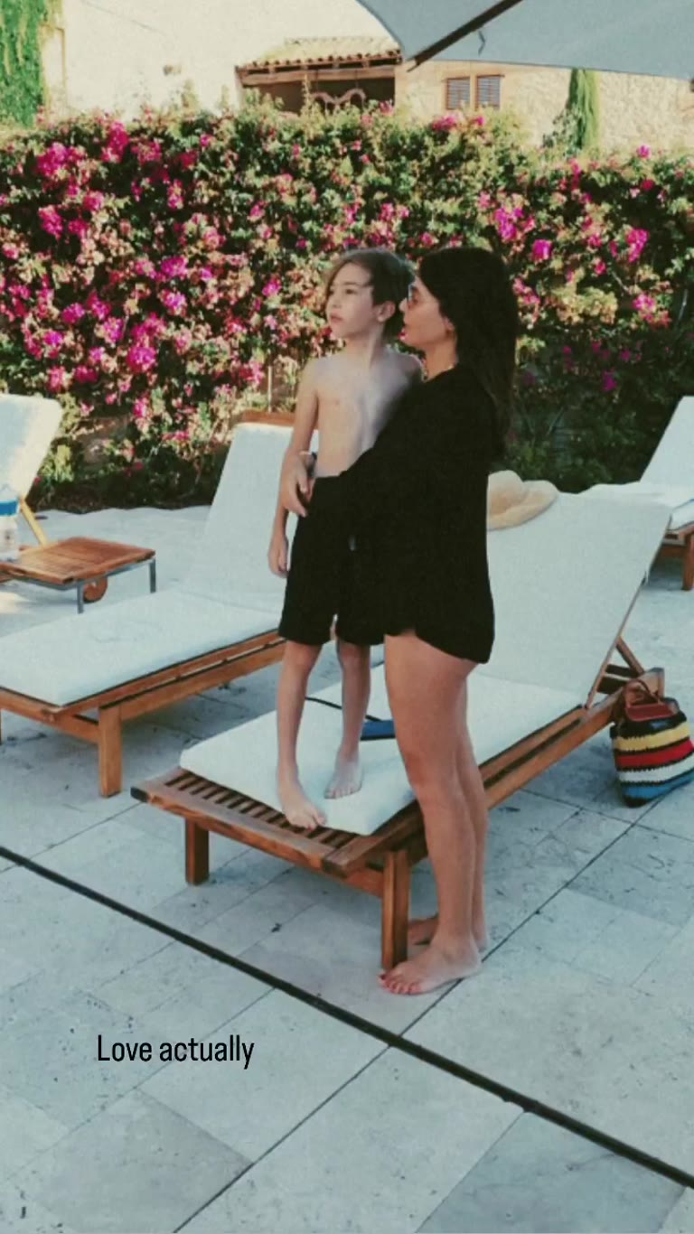 Poolside moment with her son in Spain