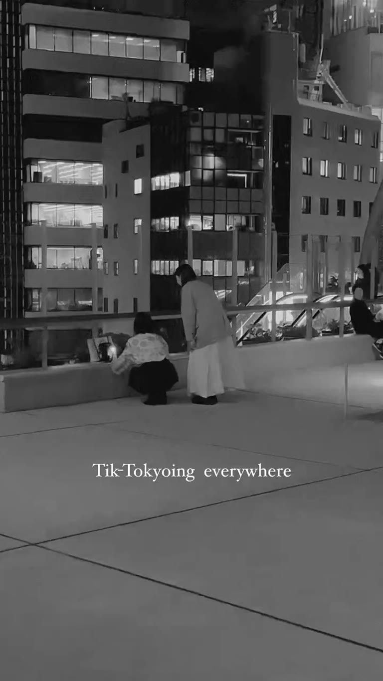 "Tik-Tokyoing everywhere" on a Tokyo plaza at night