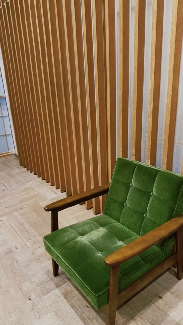 Mid-century green velvet chair in a Tokyo interior
