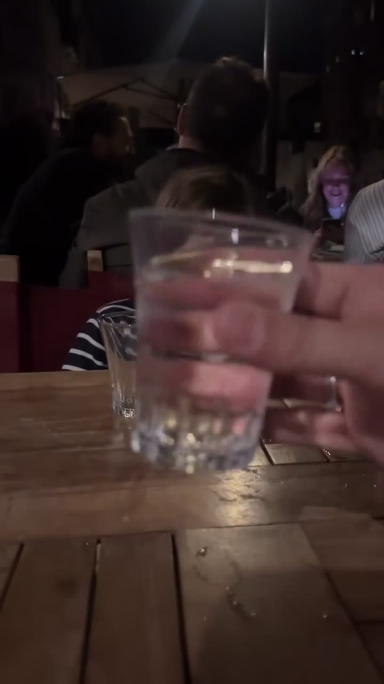 Toasting with water at a night table