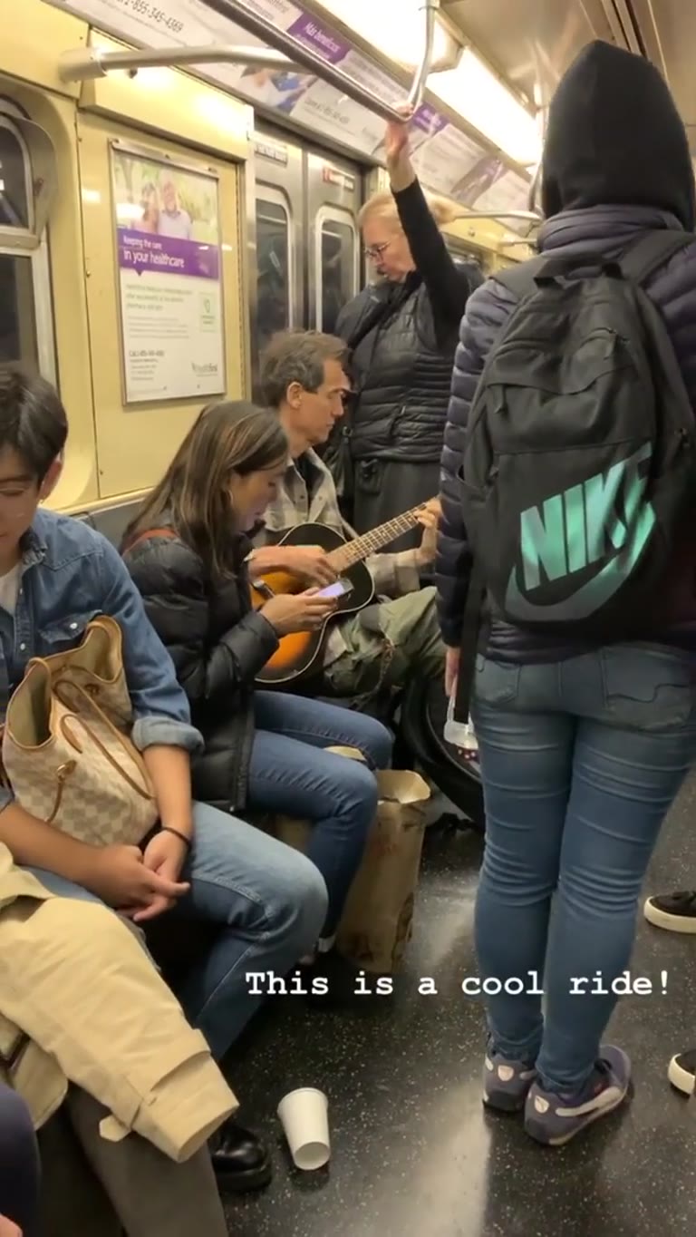 Guitar busker on the NYC subway