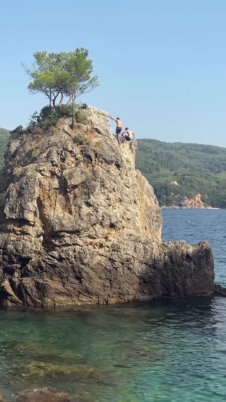 Cliff jumping at La Grotta cove, Paleokastritsa