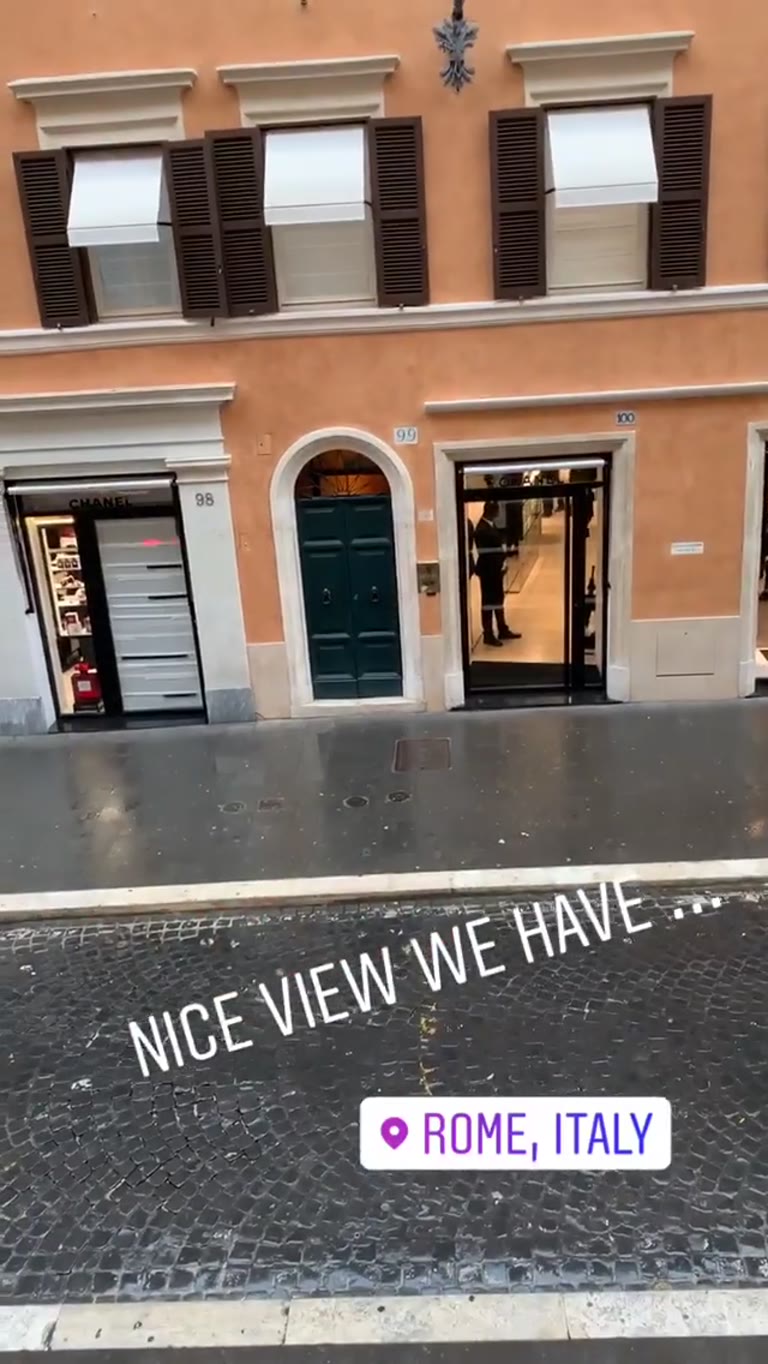 Rainy luxury shopping street in Rome