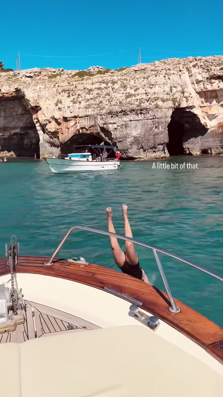 Diving off a boat into Puglia's sea caves