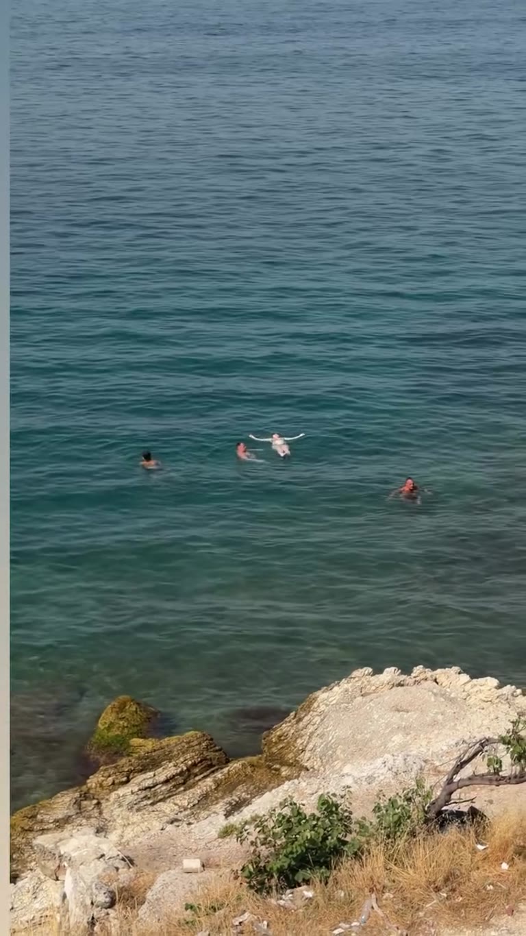 Swimming off a rocky cove in Corfu
