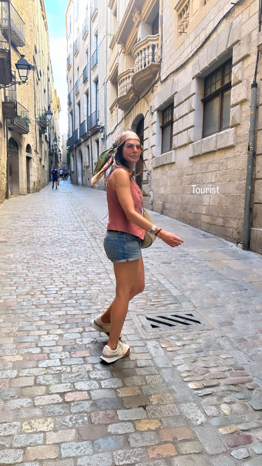 Tourist strolling a Spanish old town lane