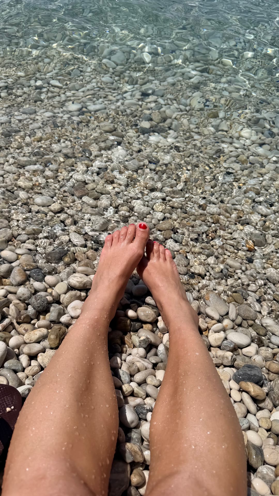 Pebble beach, clear water in Corfu