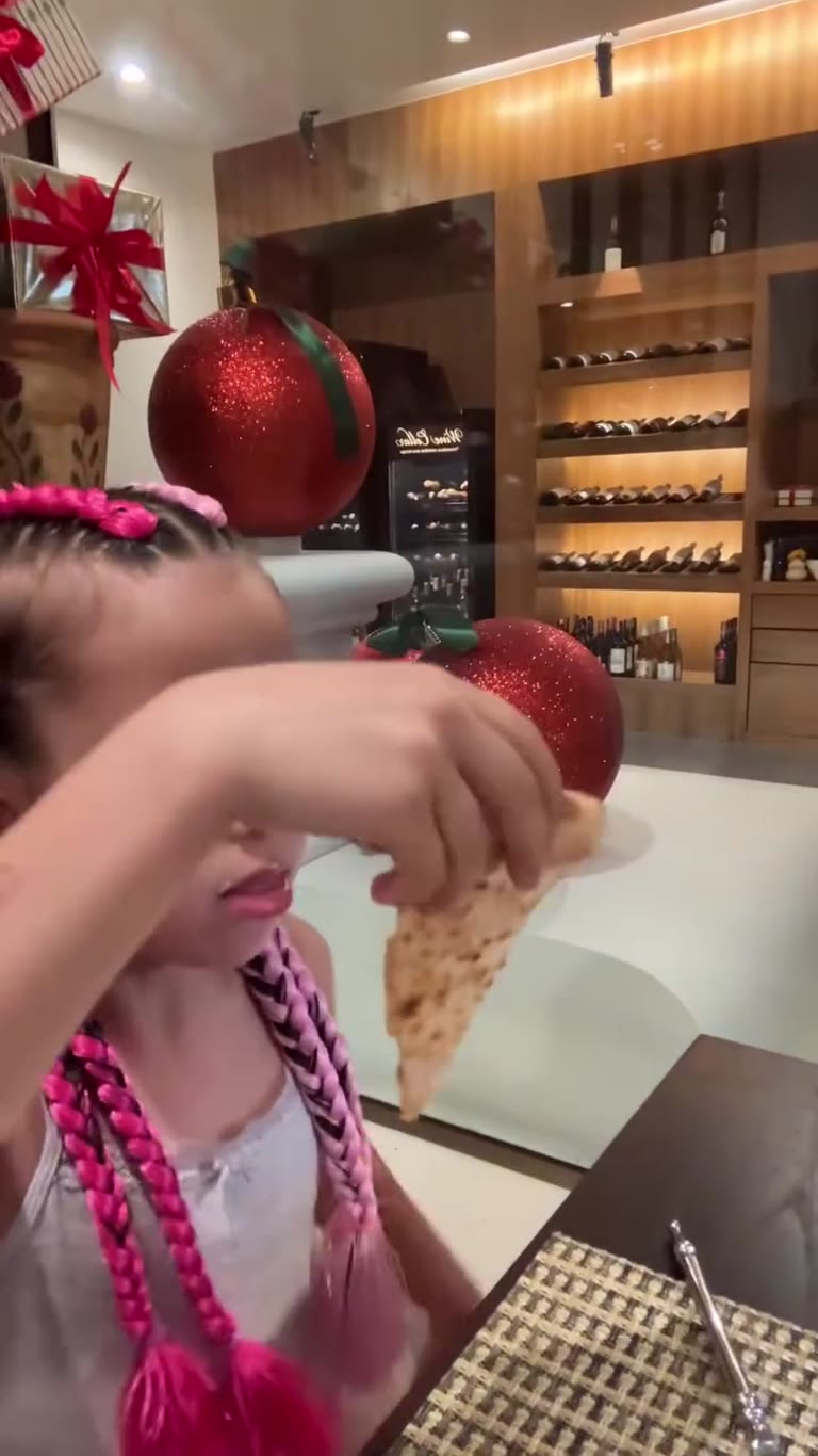 Daughter eating pizza in a Phuket restaurant