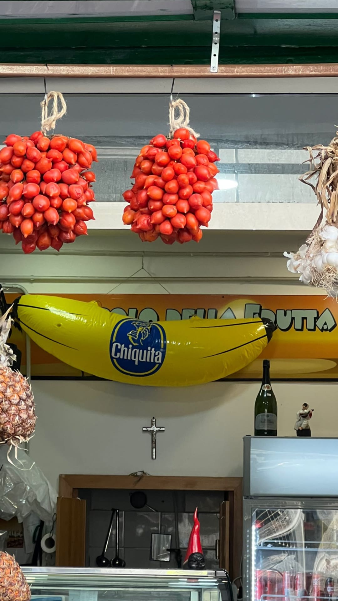 Naples fruit shop with hanging pomodorini