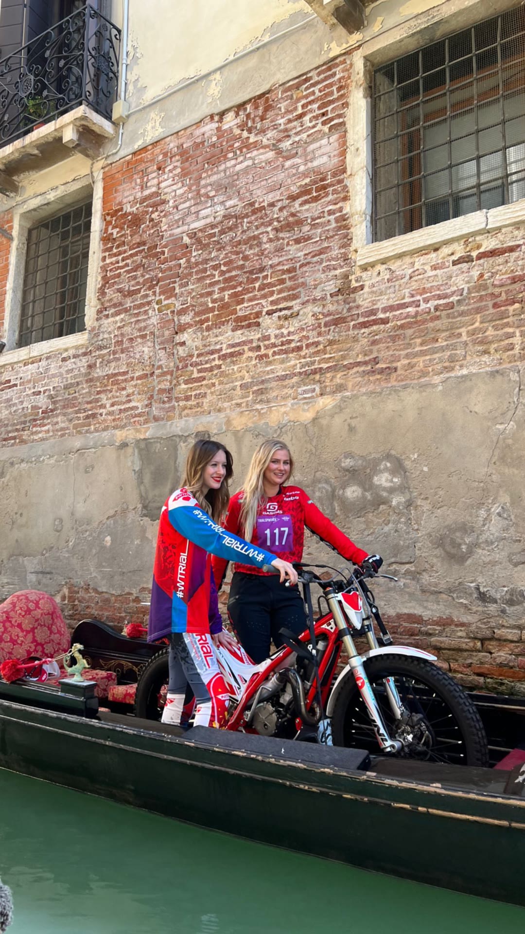 Trial riders on a gondola in Venice canals
