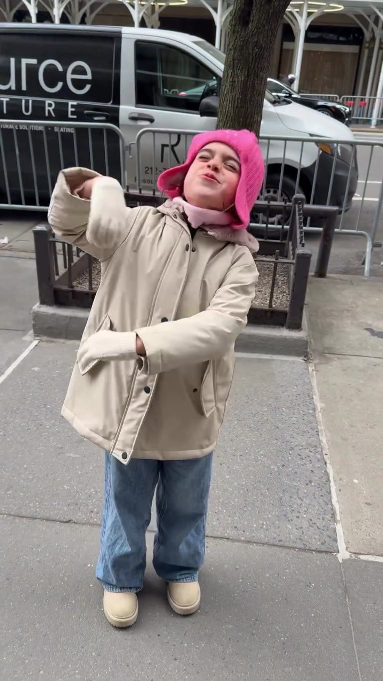 Kid dancing outside the New York Athletic Club