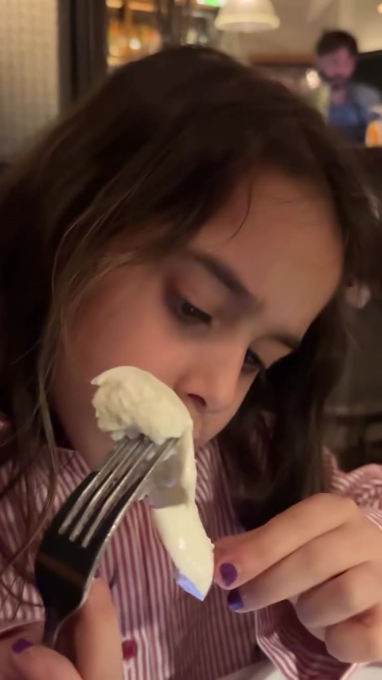 Kid tries burrata at a New York restaurant
