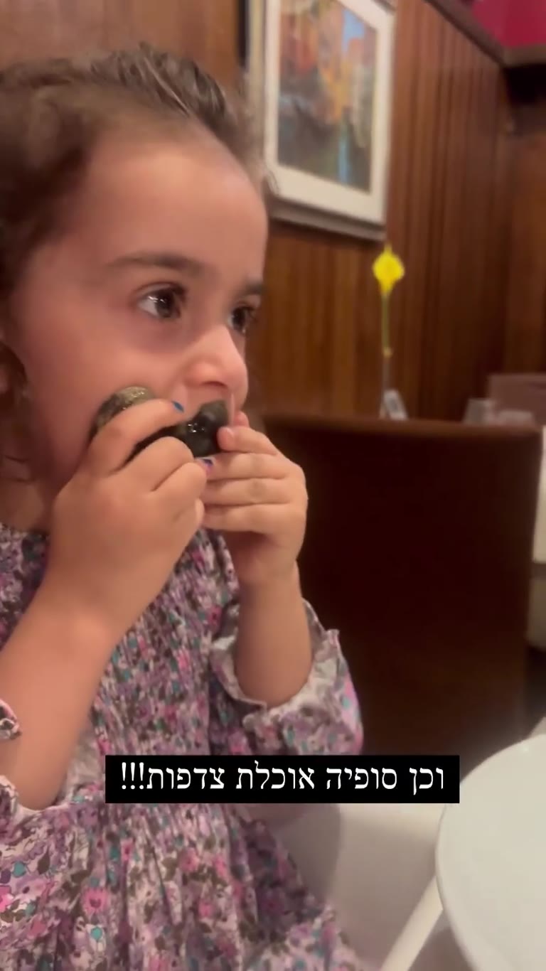 Sophia eats clams at a Venice restaurant