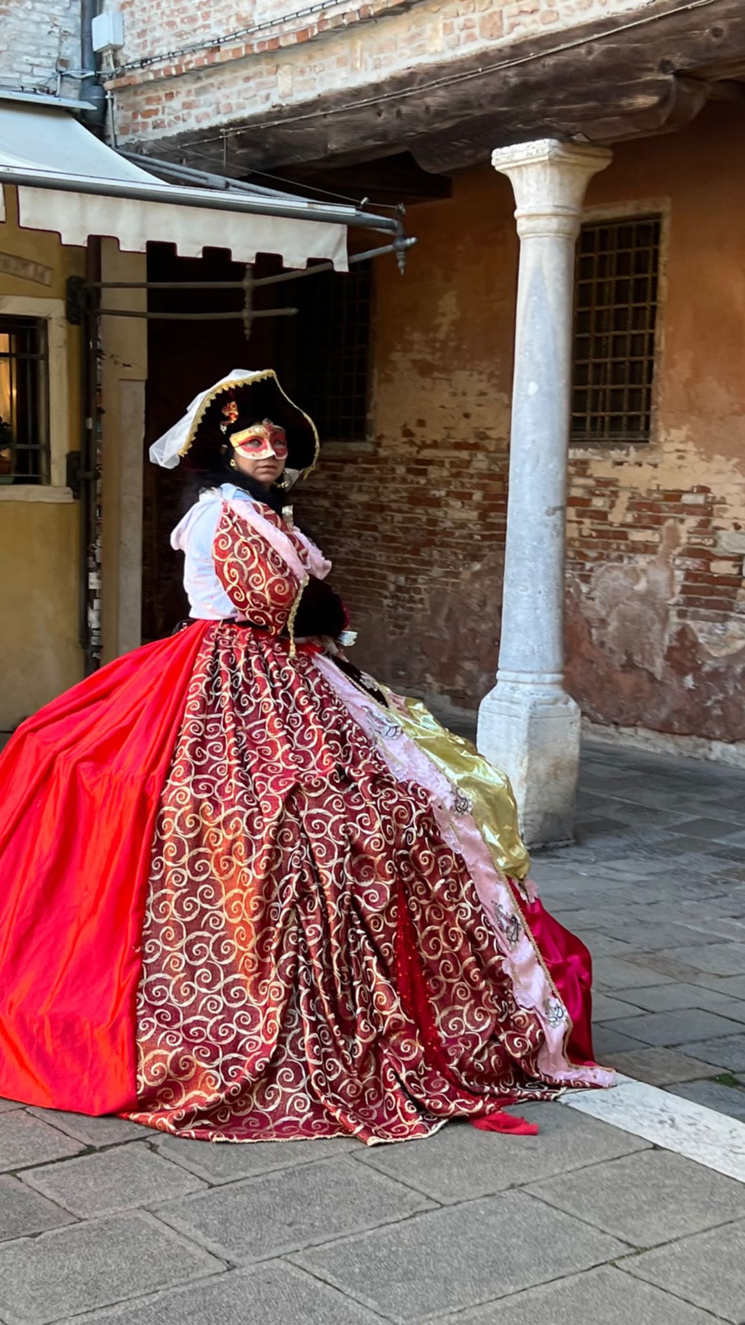 Carnival costume in a Venetian courtyard