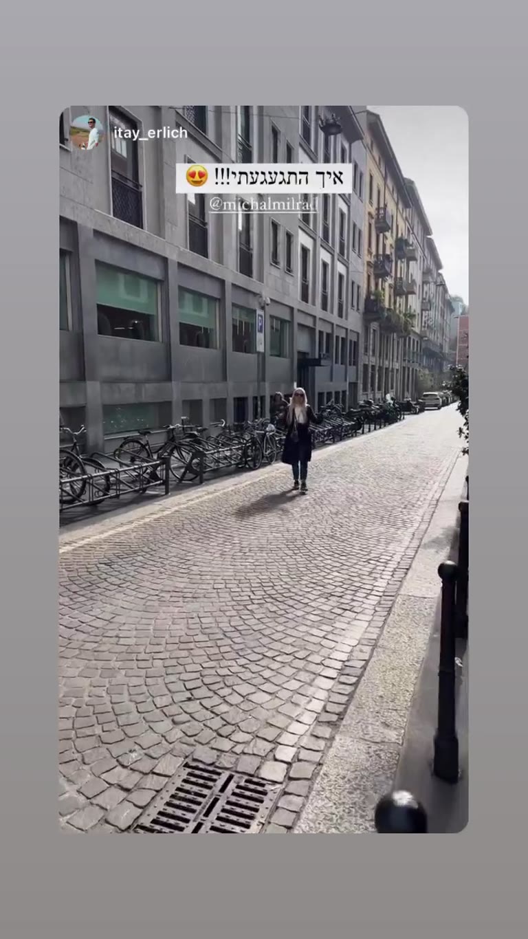 Reunion on a cobbled Milan street