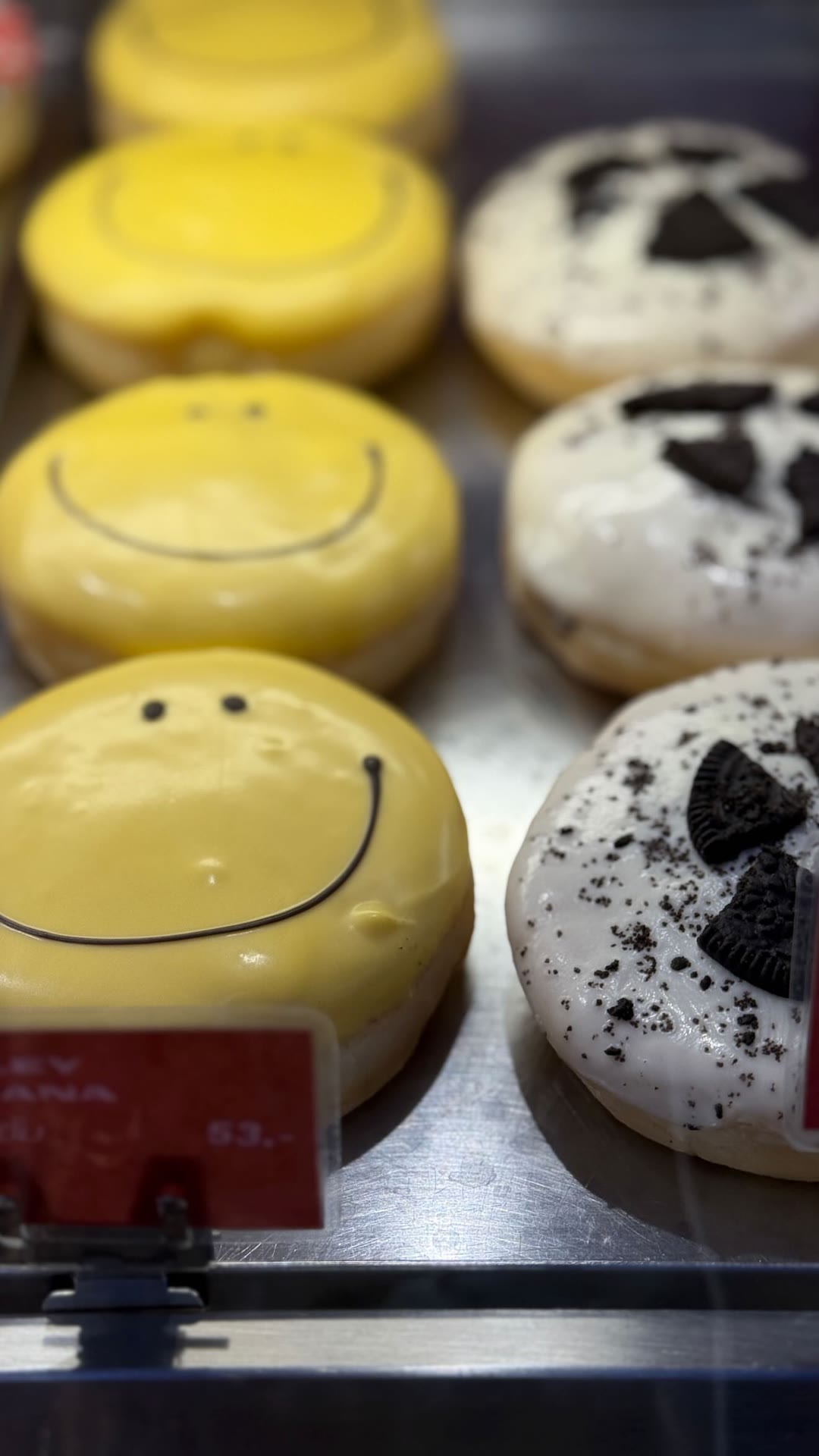 Smiley and Oreo donuts in a Bangkok display case
