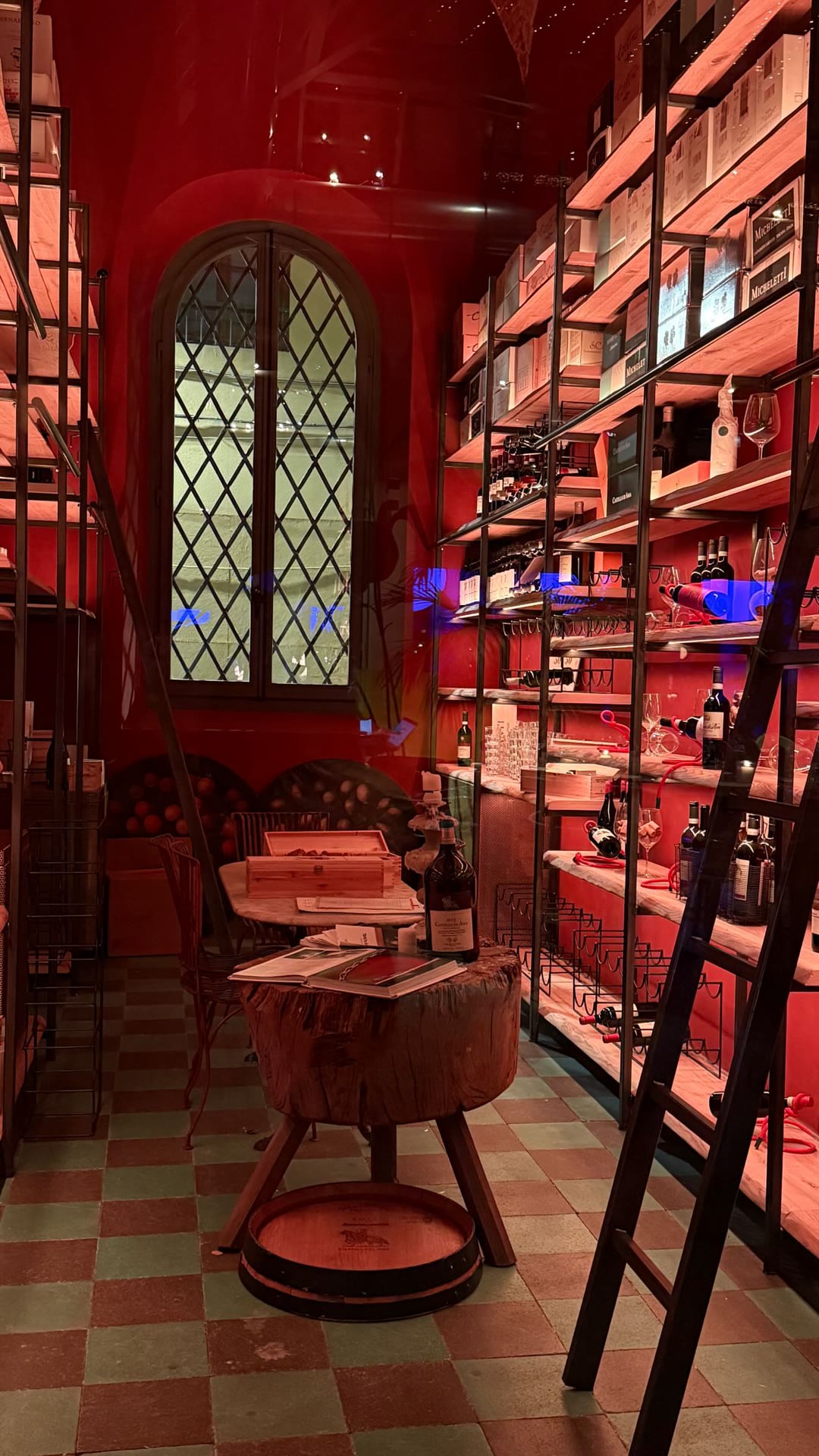 Red-lit wine shop interior in Florence