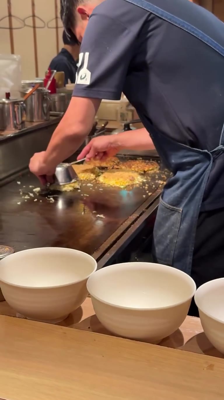 Okonomiyaki cooked at the counter in Osaka