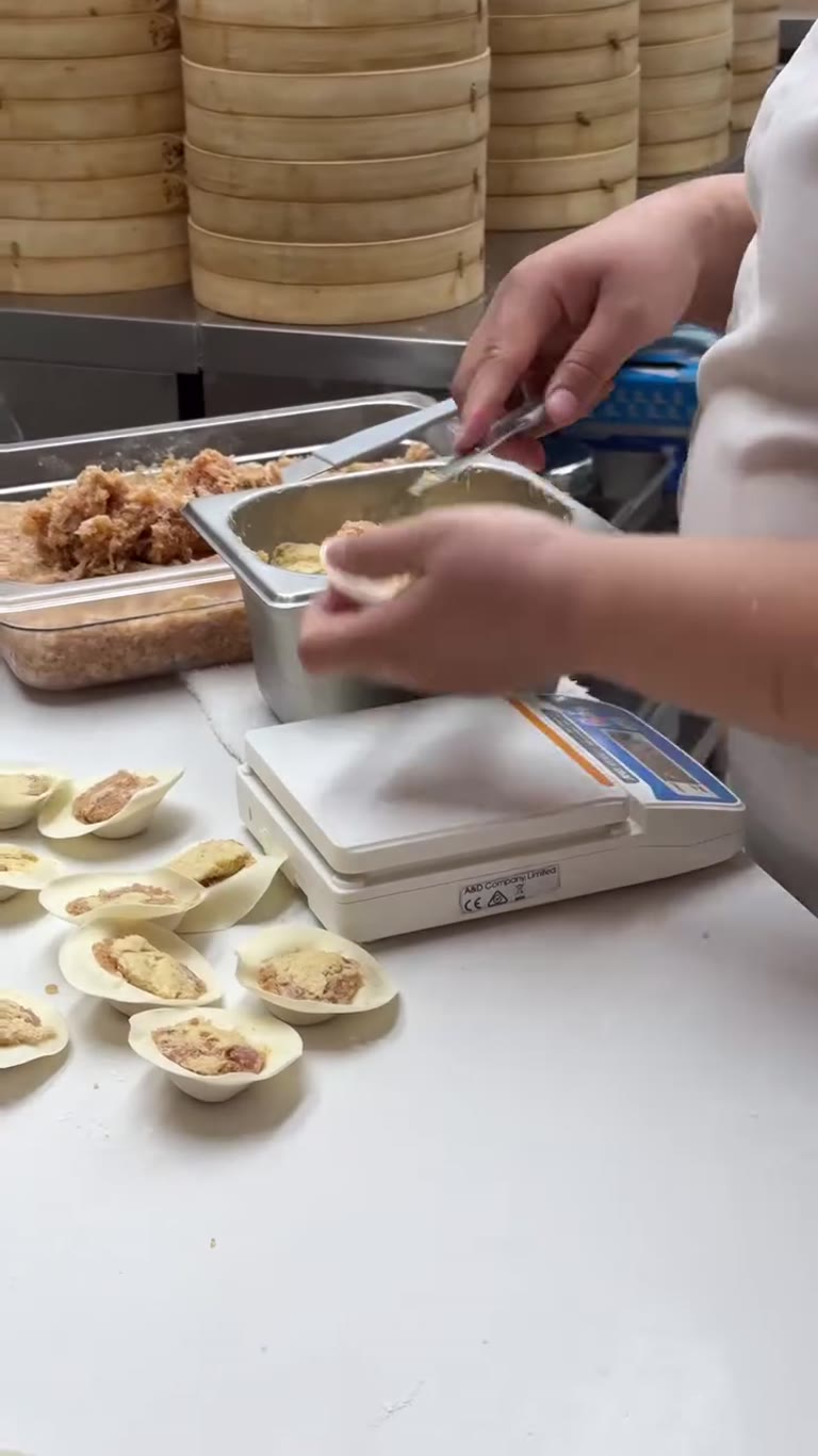 Dumplings being hand-filled in a Phuket kitchen