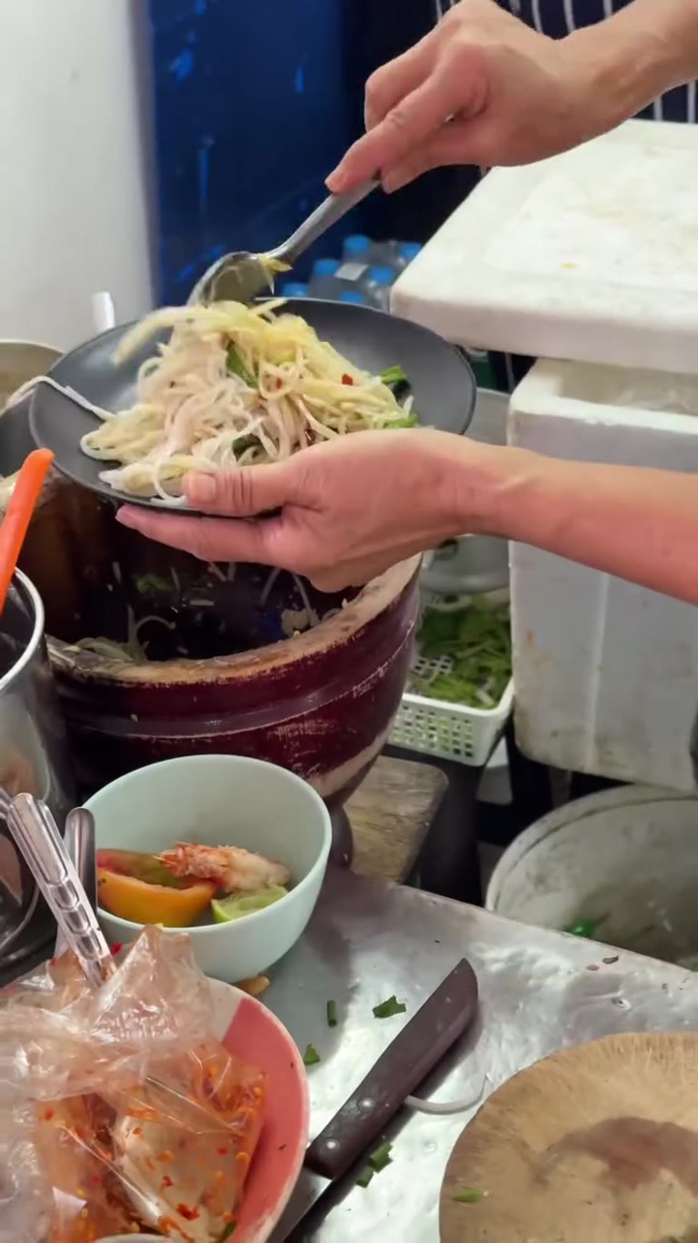 Som tam with noodles at a Bangkok street stall