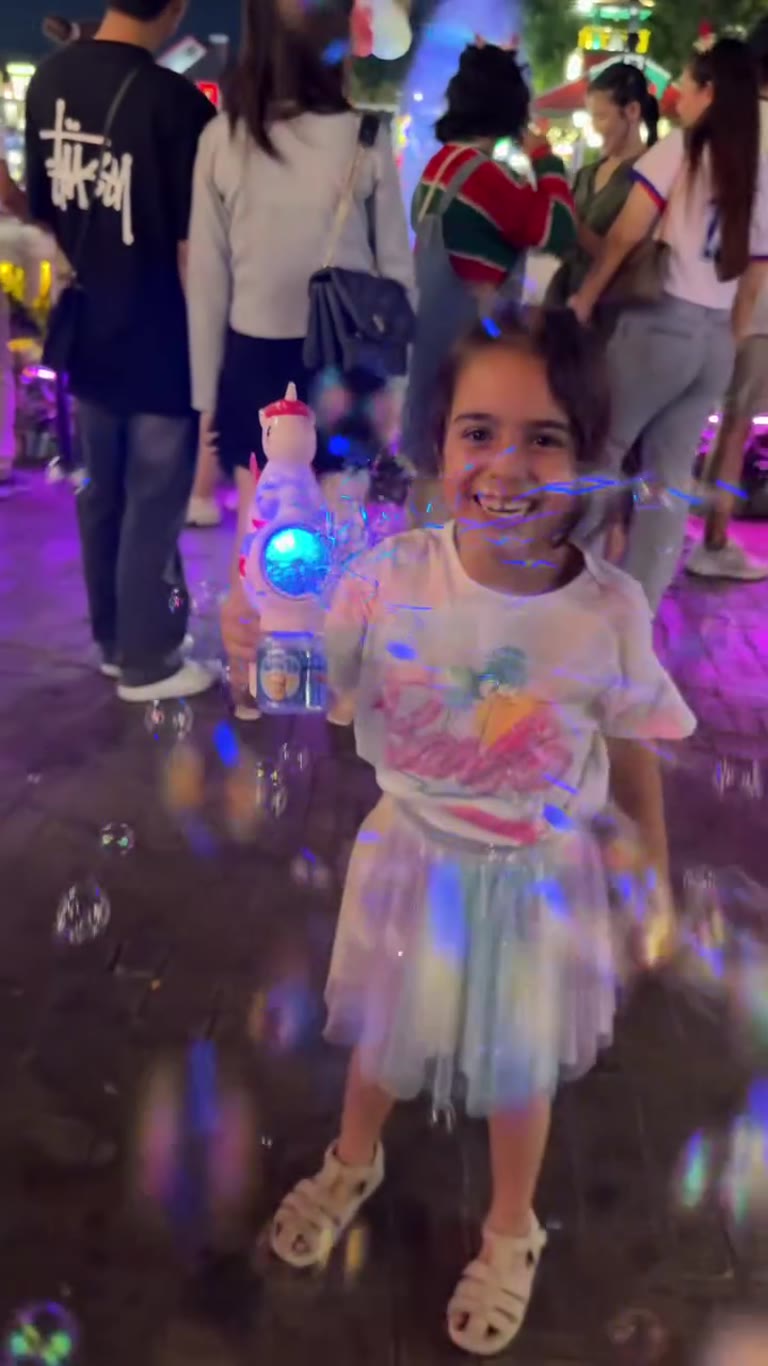 Bubble gun fun on a Bangkok street at night