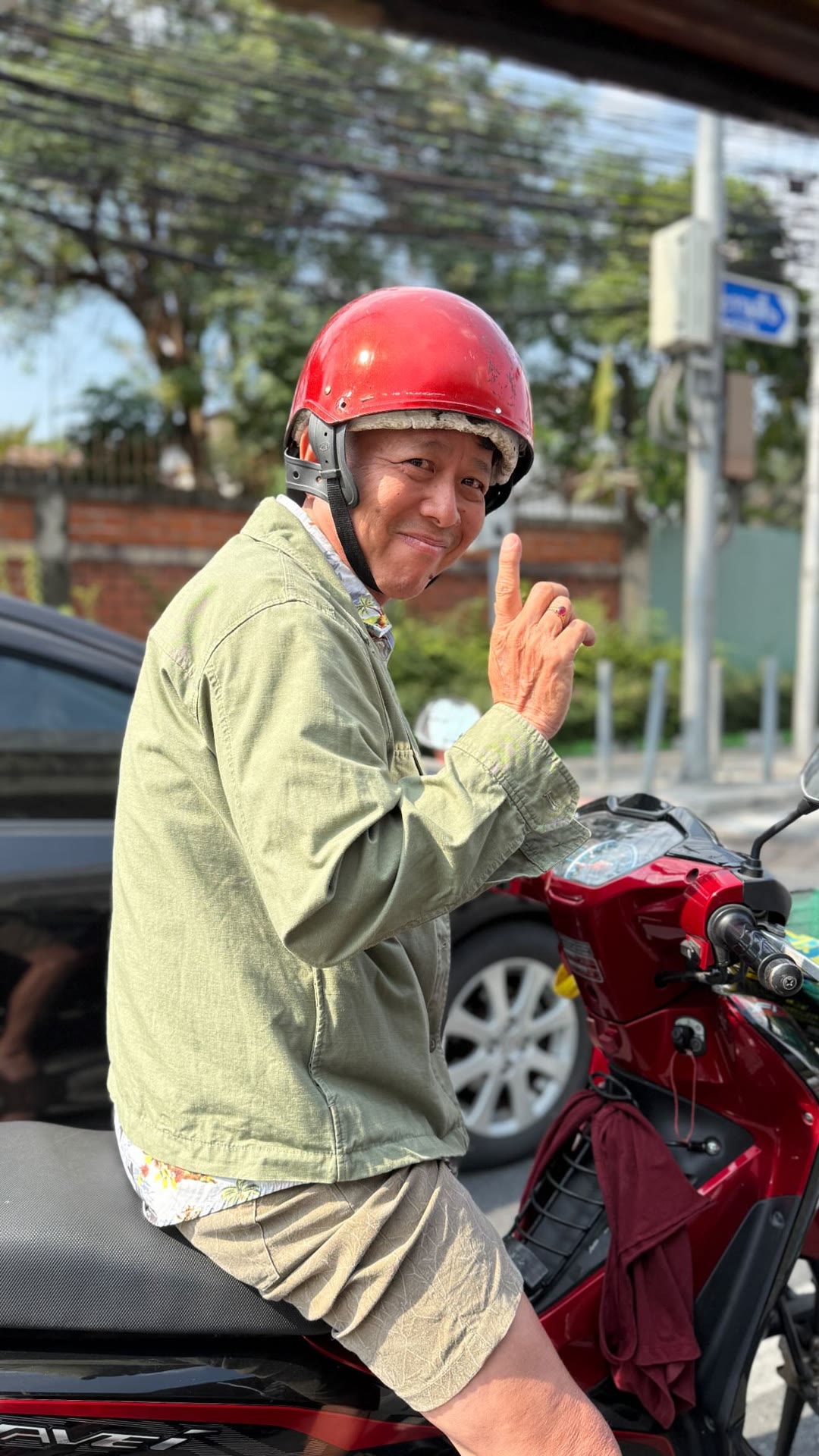 Smiling motorbike rider in Bangkok
