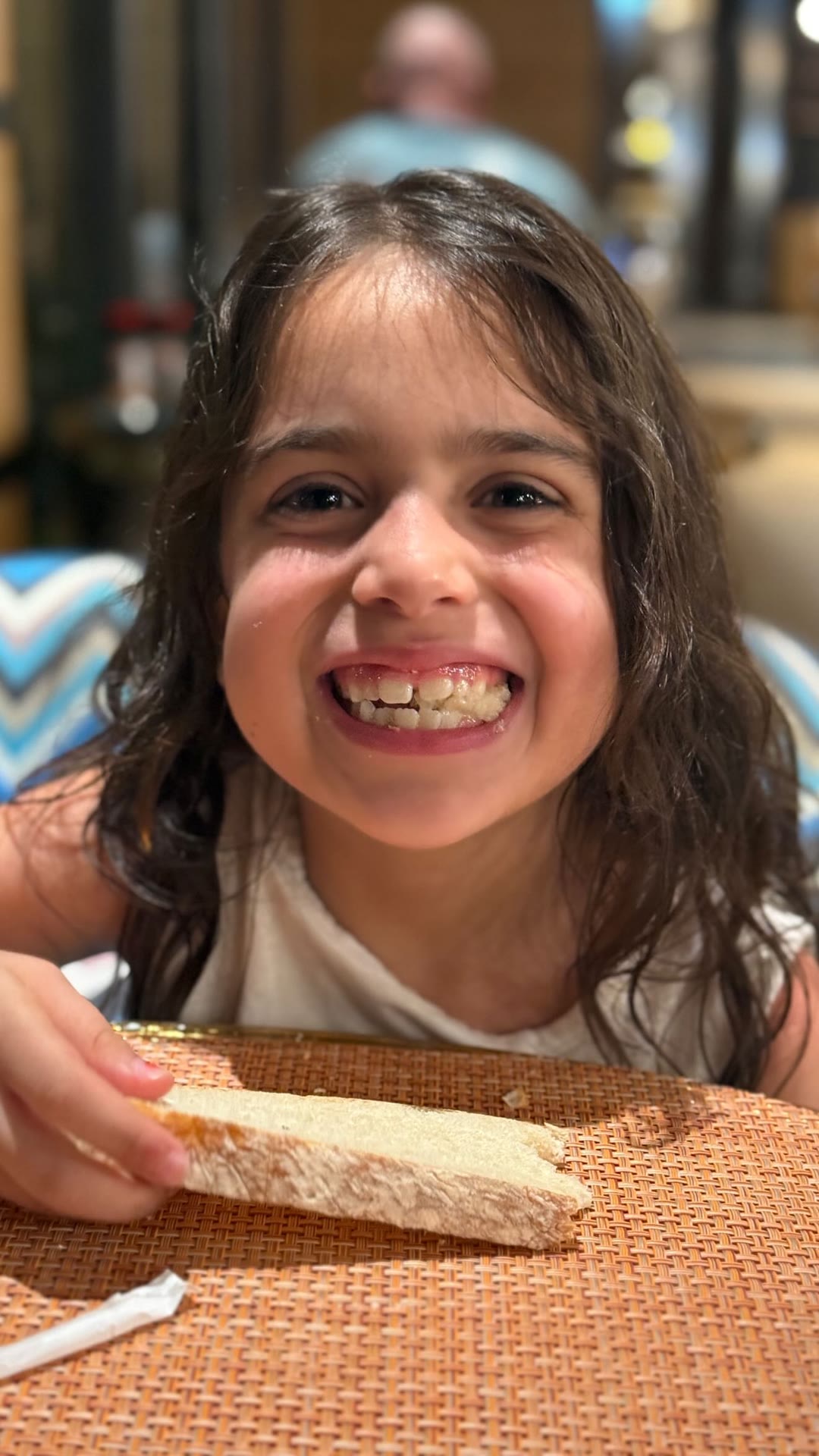 Smiling with bread at dinner in Phuket