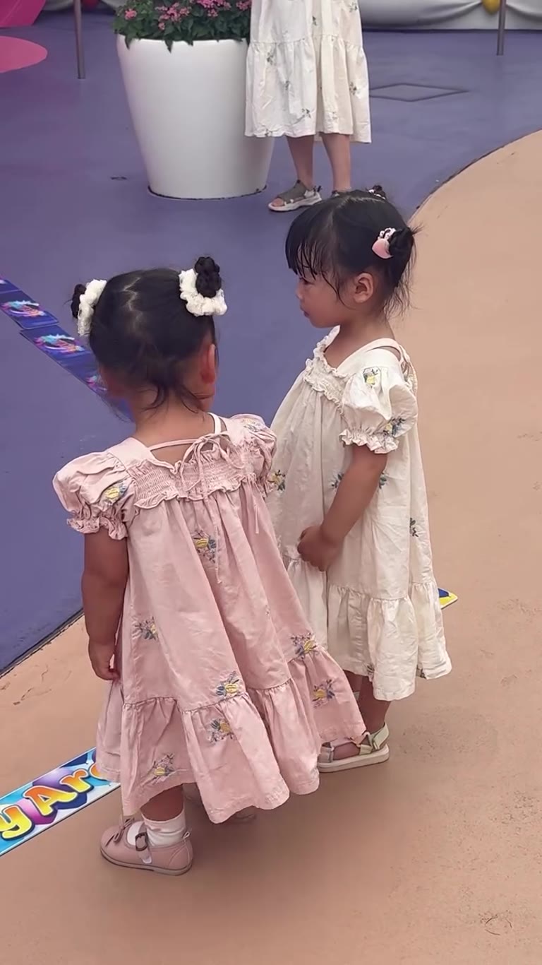 Two toddlers in matching dresses, Osaka