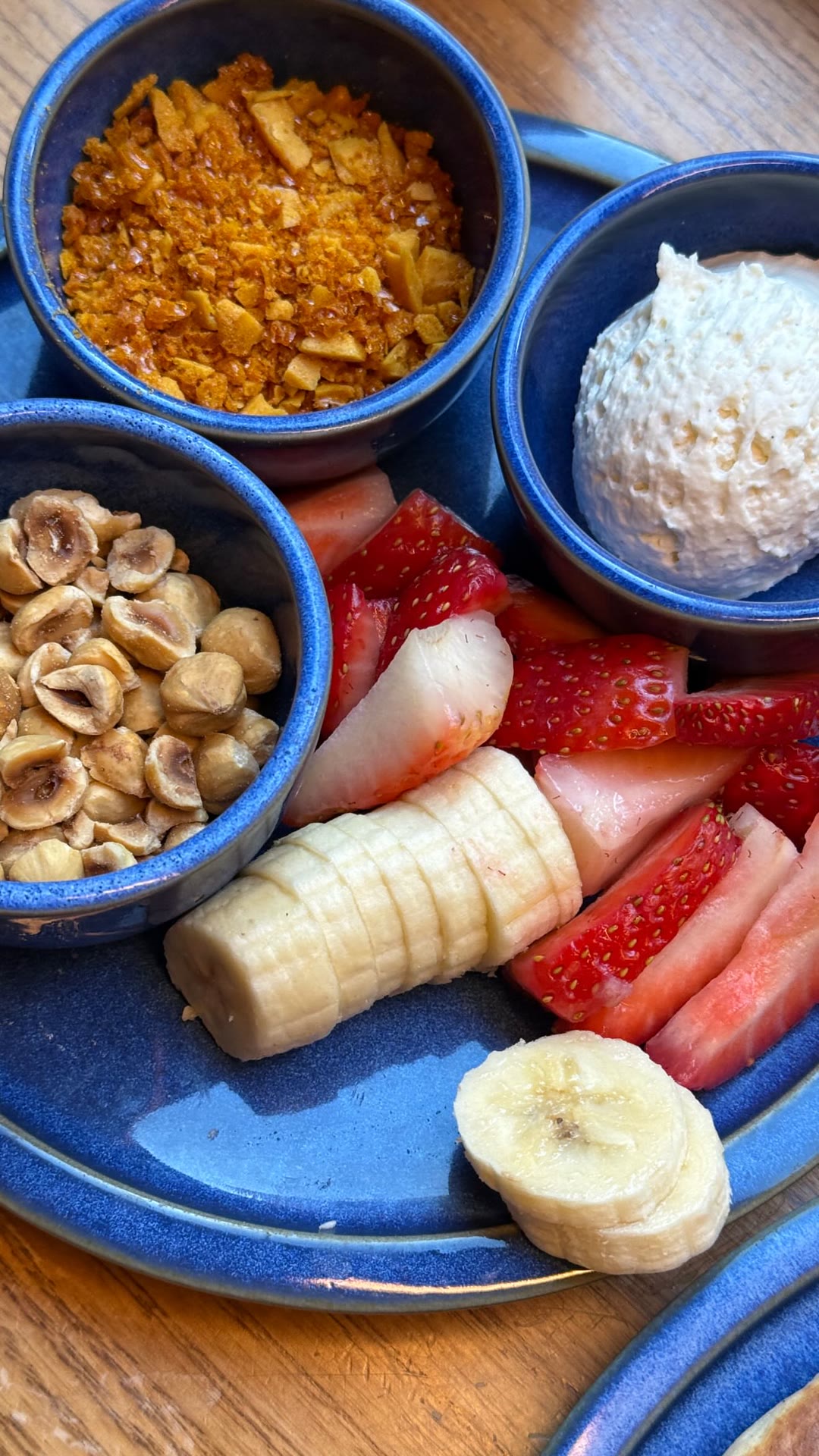 Breakfast plate with fruit, nuts and cream