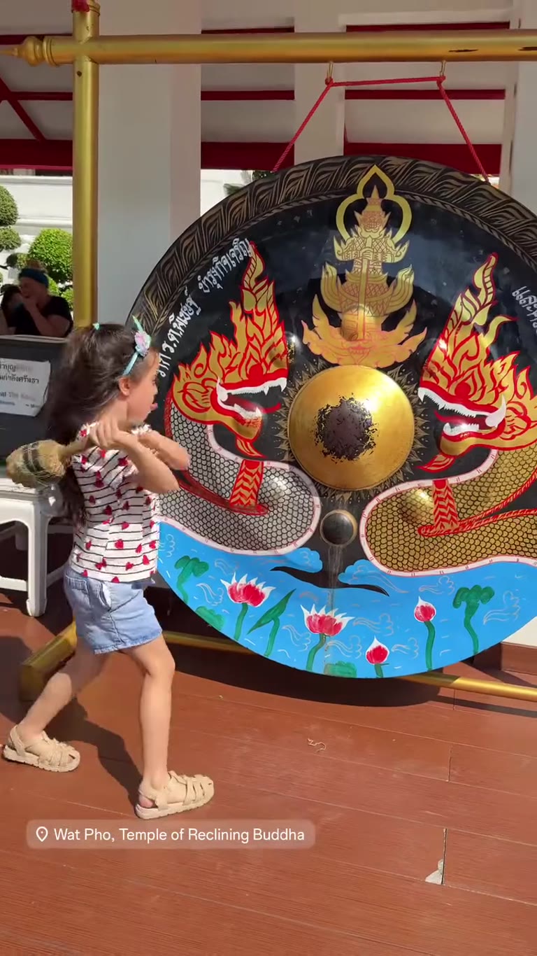 Striking the gong at Wat Pho, Bangkok
